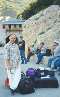 Costas minds the bags while we wait forthe only boat of the day